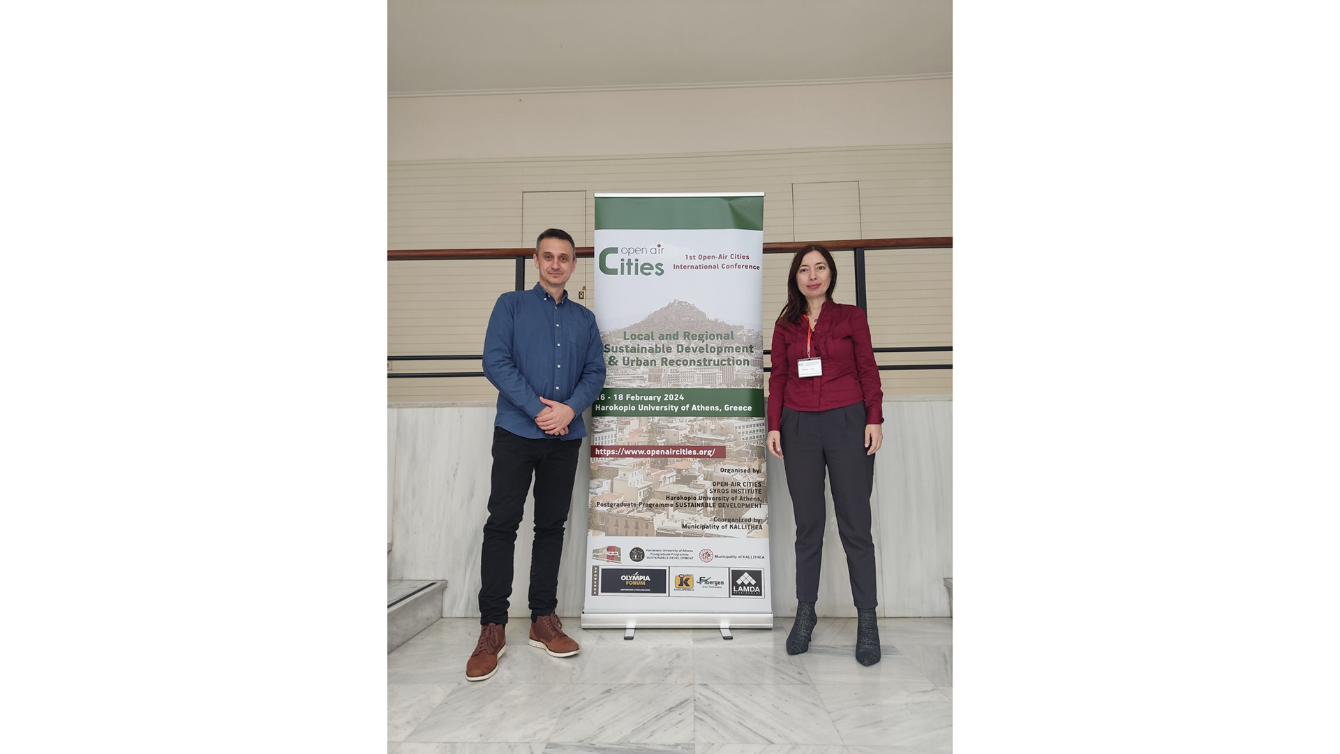 Two consortium presenters standing by their scientific poster